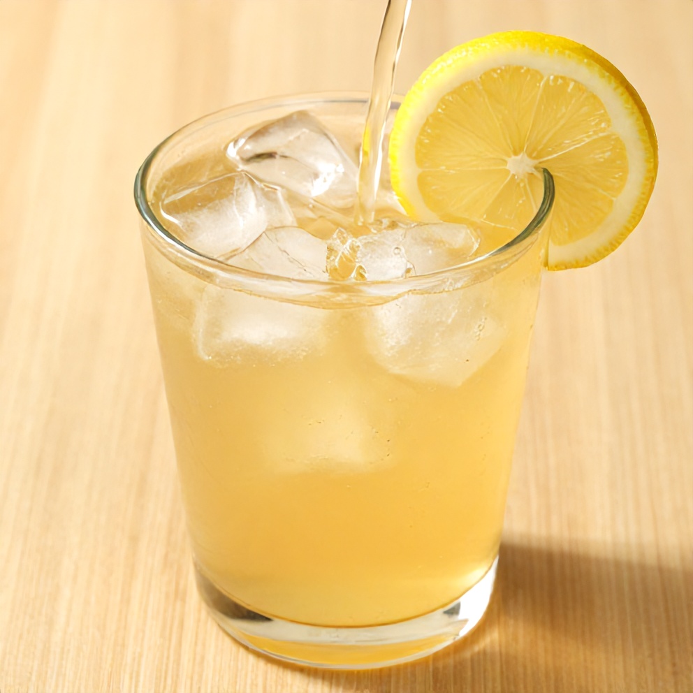 Guava White Tea Lemonade poured in a glass with a lemon wheel garnish