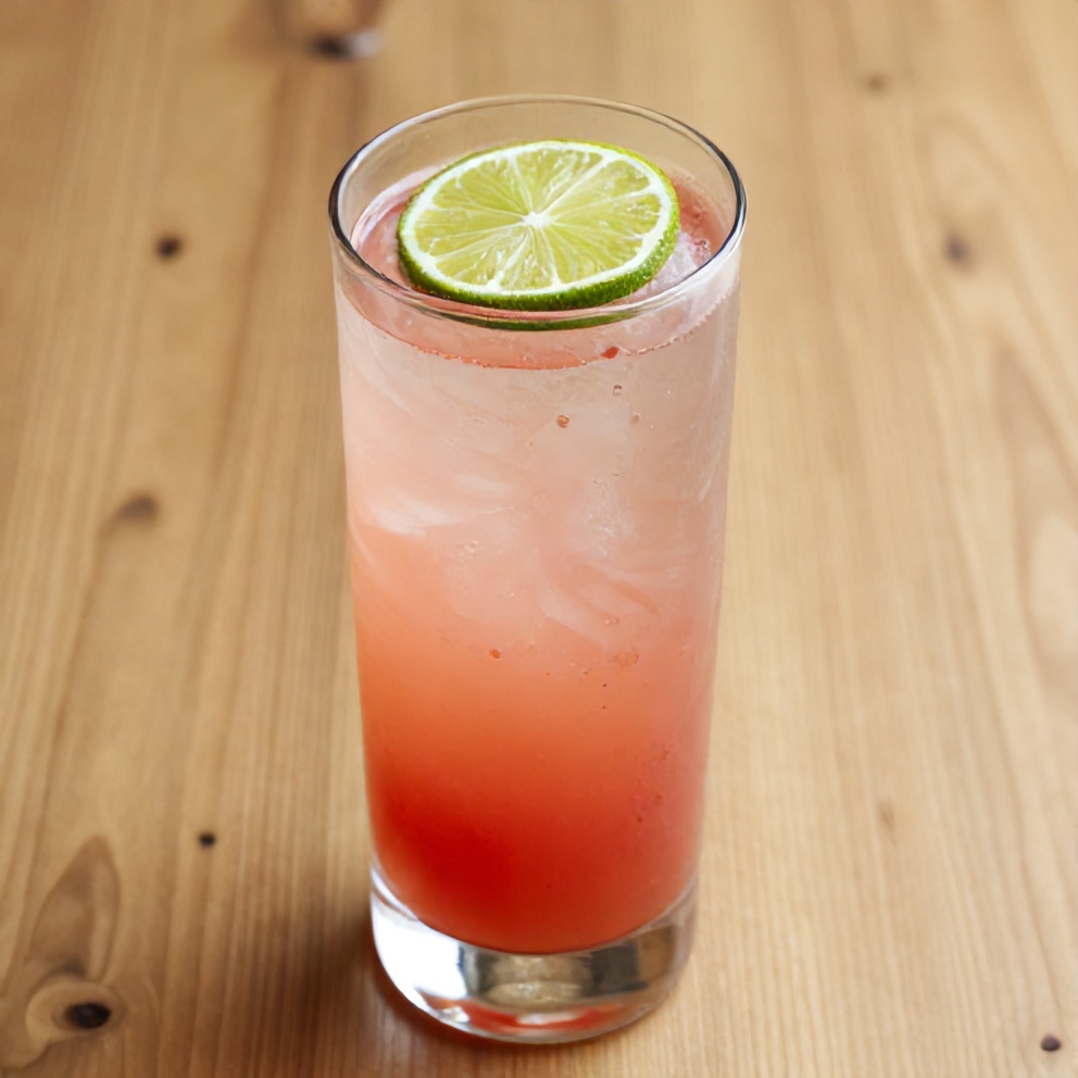 Glass of hibiscus lime sparkling water with lime wheel garnish